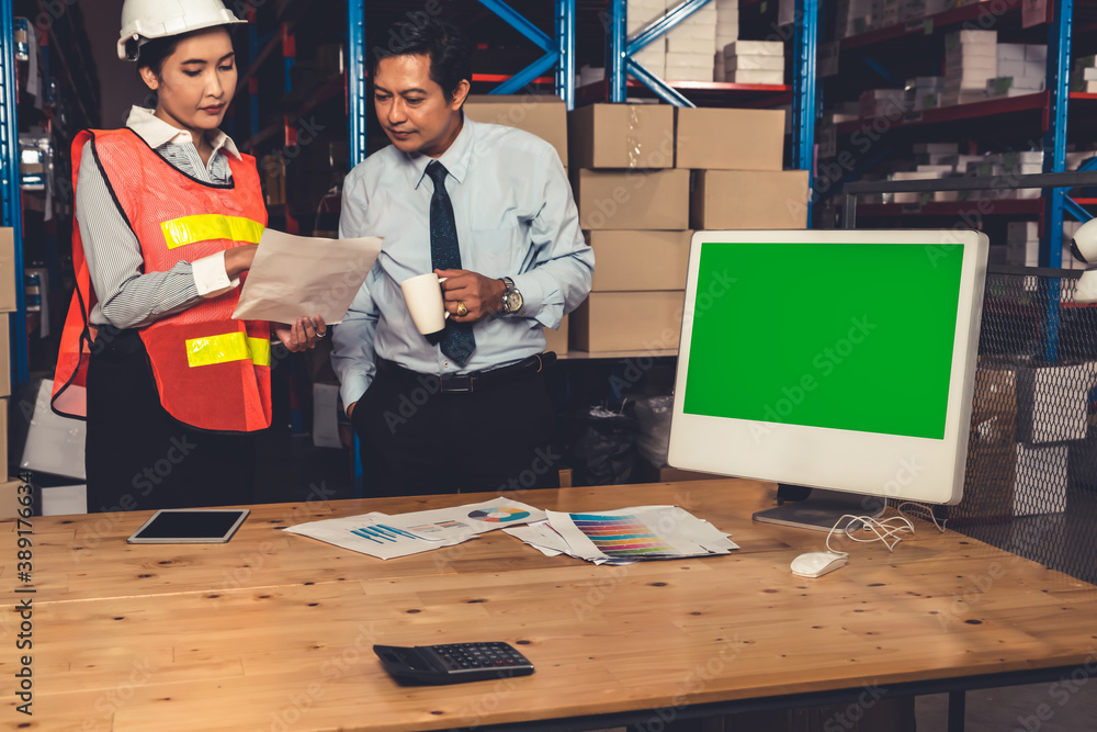 Computer with green screen display in warehouse storage room . Delivery and transportation software 