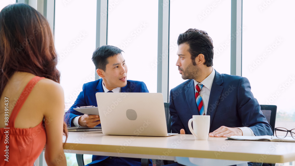 Job seeker in job interview meeting with manager and interviewer at corporate office. The young inte