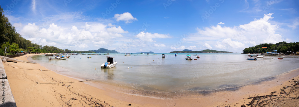 Tropical beach panorama with LongTail boats in the sea blue sky and white clouds in summer season.