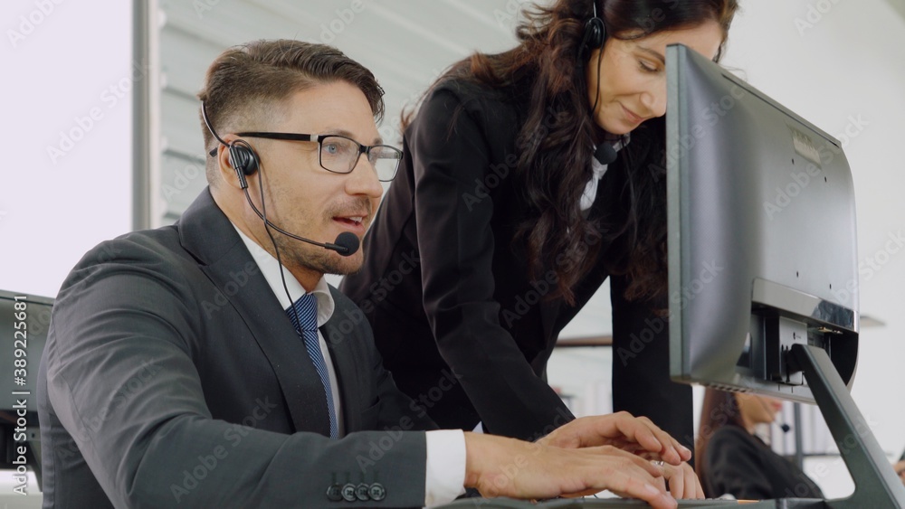 Business people wearing headset working in office to support remote customer or colleague. Call cent