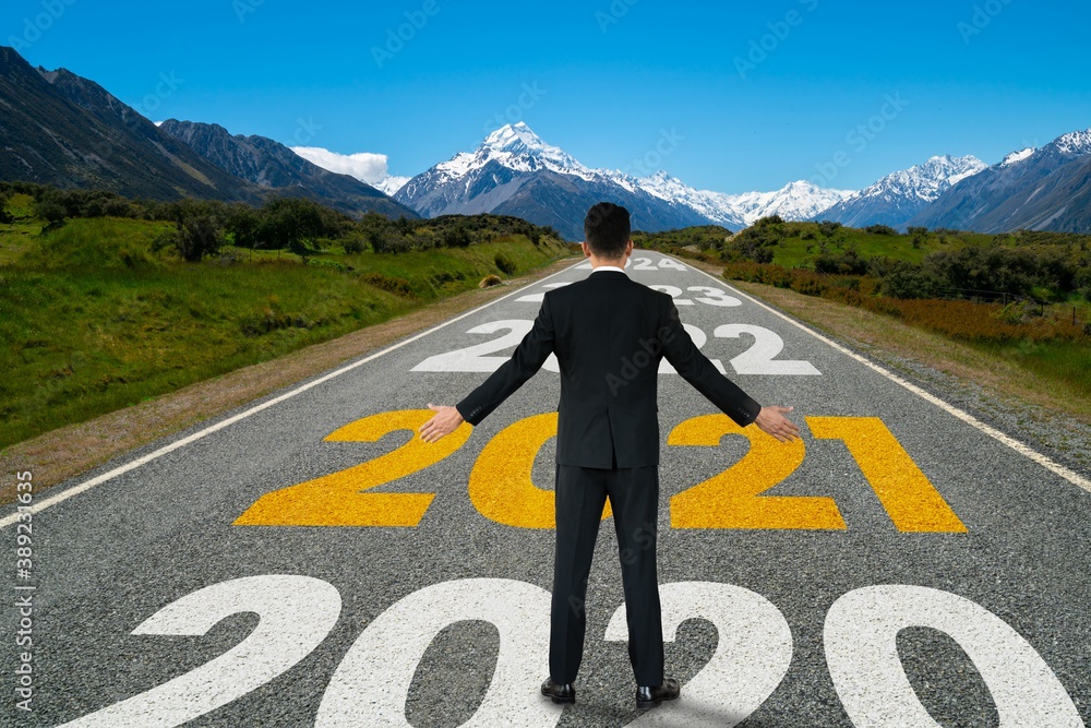 The 2021 New Year journey and future vision concept . Businessman traveling on highway road leading 