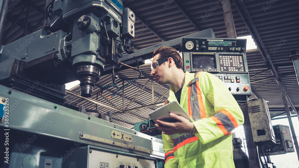 Smart factory worker using machine in factory workshop . Industry and engineering concept.