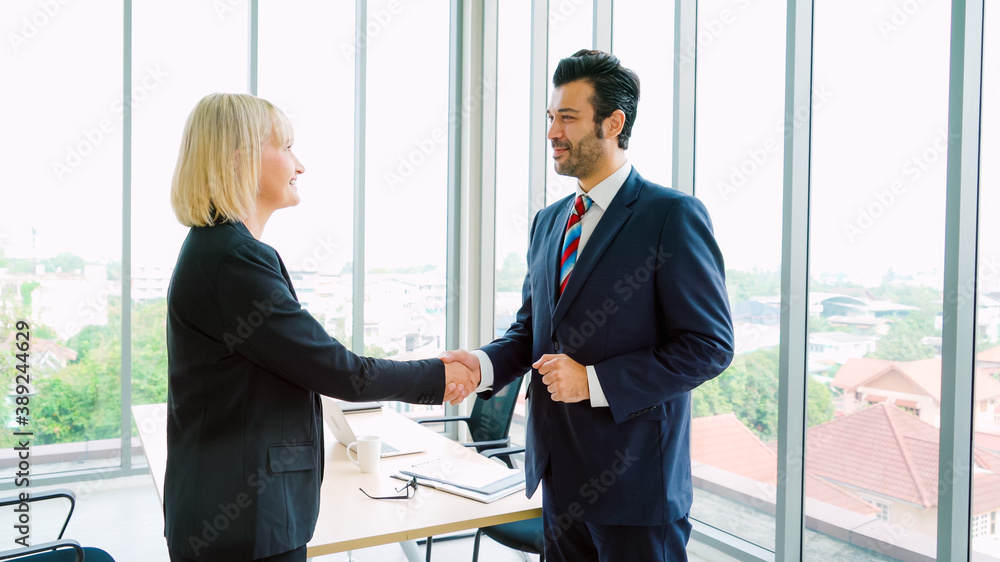 Business people handshake in corporate office showing professional agreement on a financial deal con