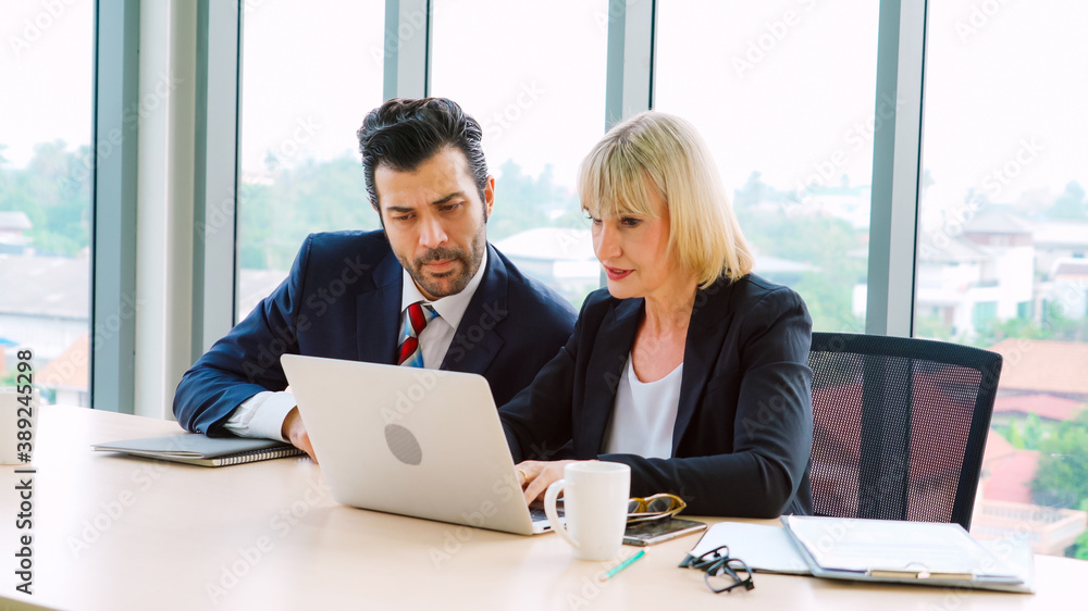 Two business people talk project strategy at office meeting room. Businessman discuss project planni