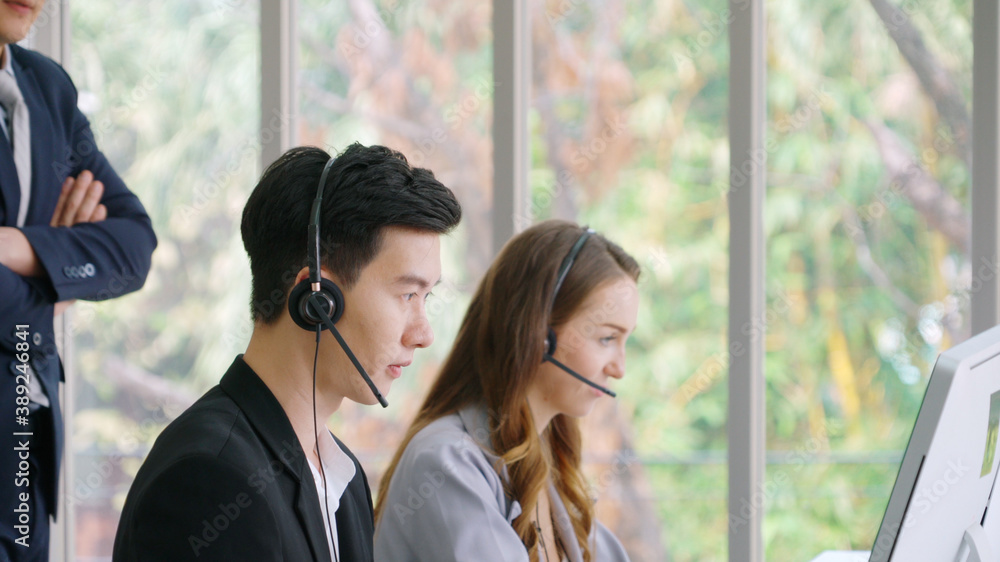 Business people wearing headset working in office to support remote customer or colleague. Call cent