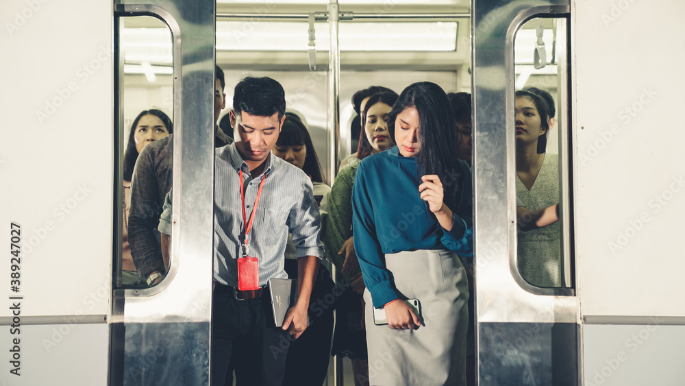 Crowd of people on a busy crowded public subway train travel . Commuting and urban lifestyle concept