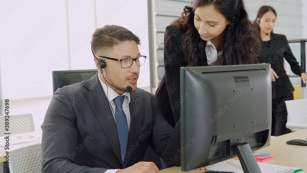 Business people wearing headset working in office to support remote customer or colleague. Call cent