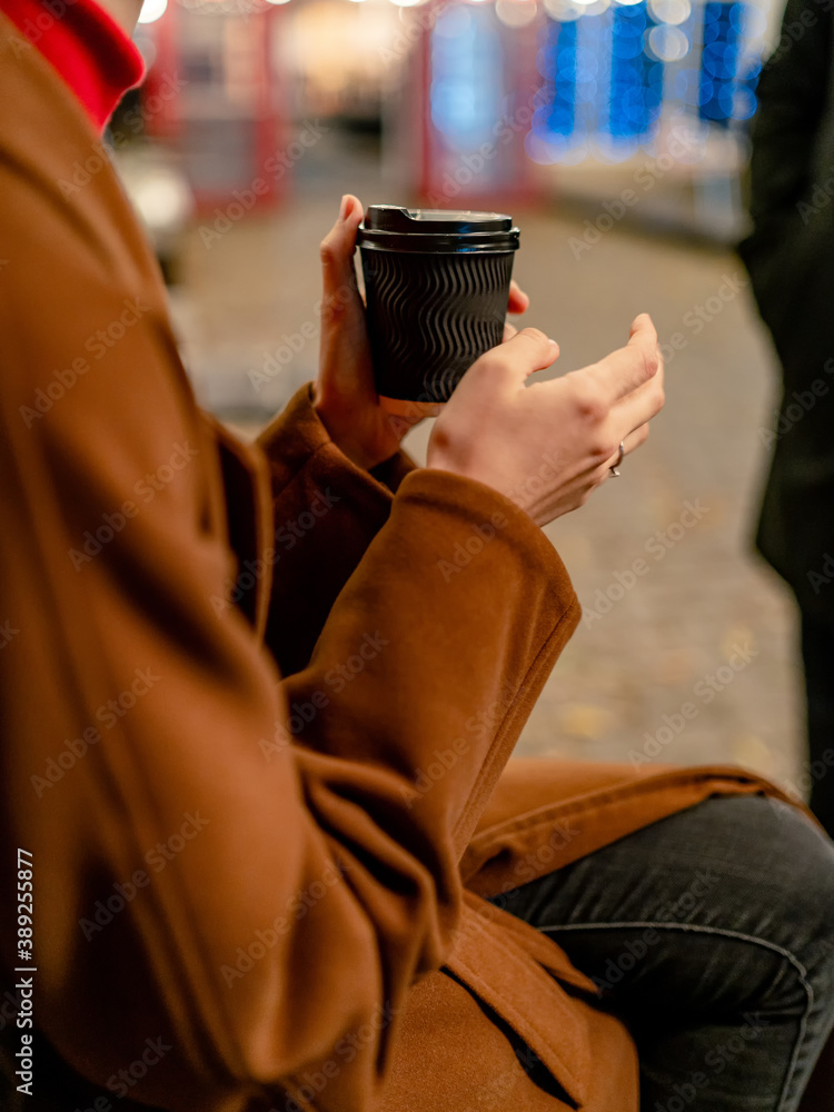 Business man relaxing outdoor drinking black coffee in the evening. Close up.