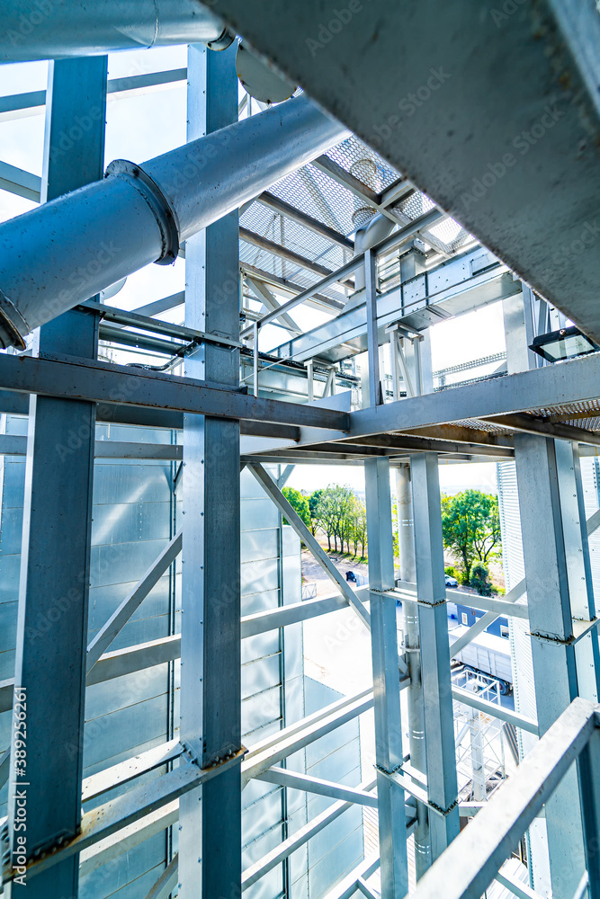 Industrial metal air flow and air conditioning pipes on the ceiling of an industrial factory. Keepin