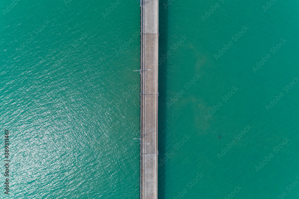 Aerial top view drone shot of small bridge in the sea image transportation background concept.