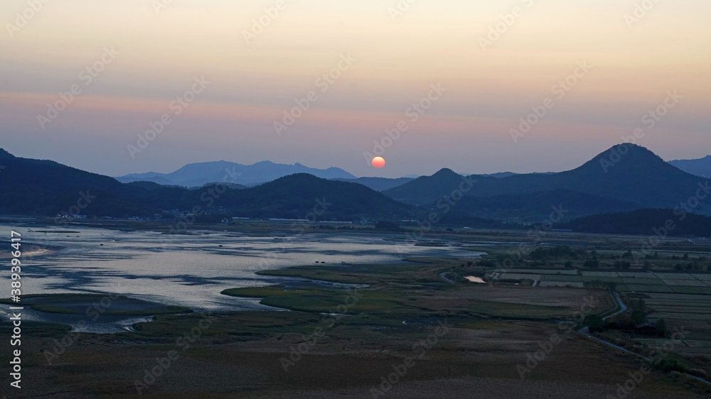 a wetland where the sun is going down