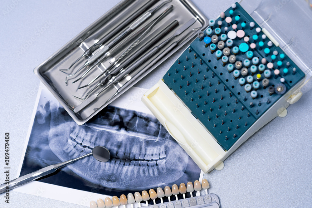 X-ray of teeth. Set of metal dental tools for dental care and prosthetics. Selective focus.