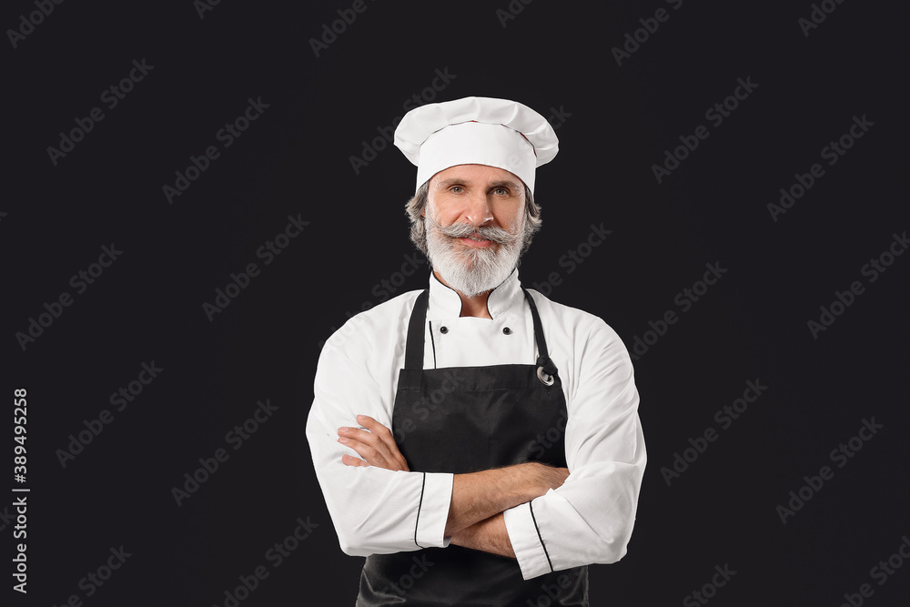 Mature male chef on dark background