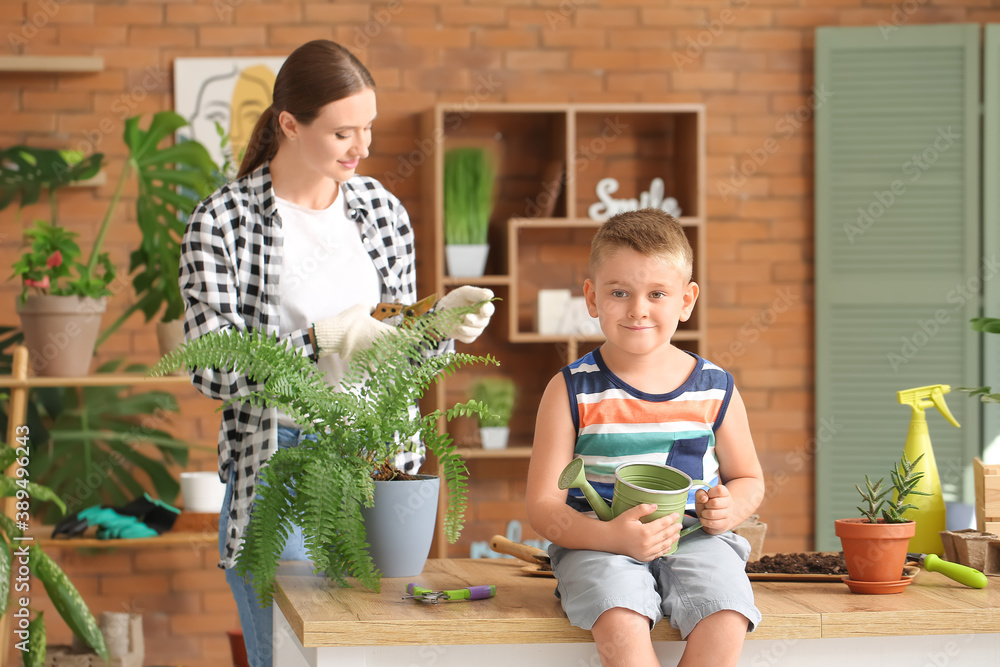 Young mother with son setting out plants at home