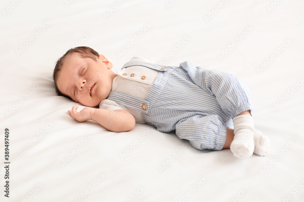 Cute little baby lying on bed