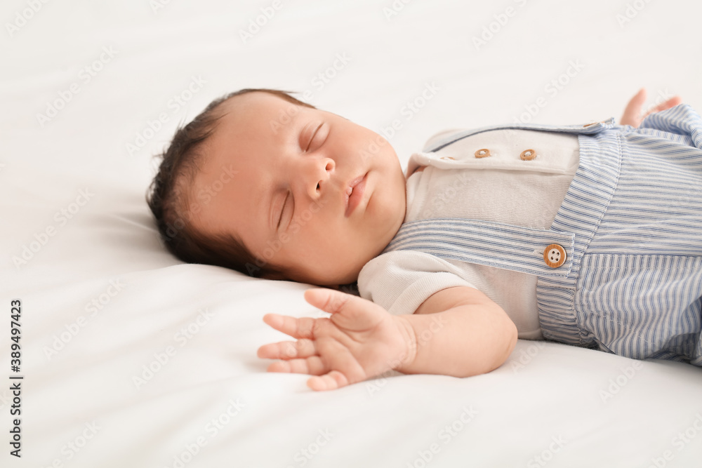 Cute little baby lying on bed