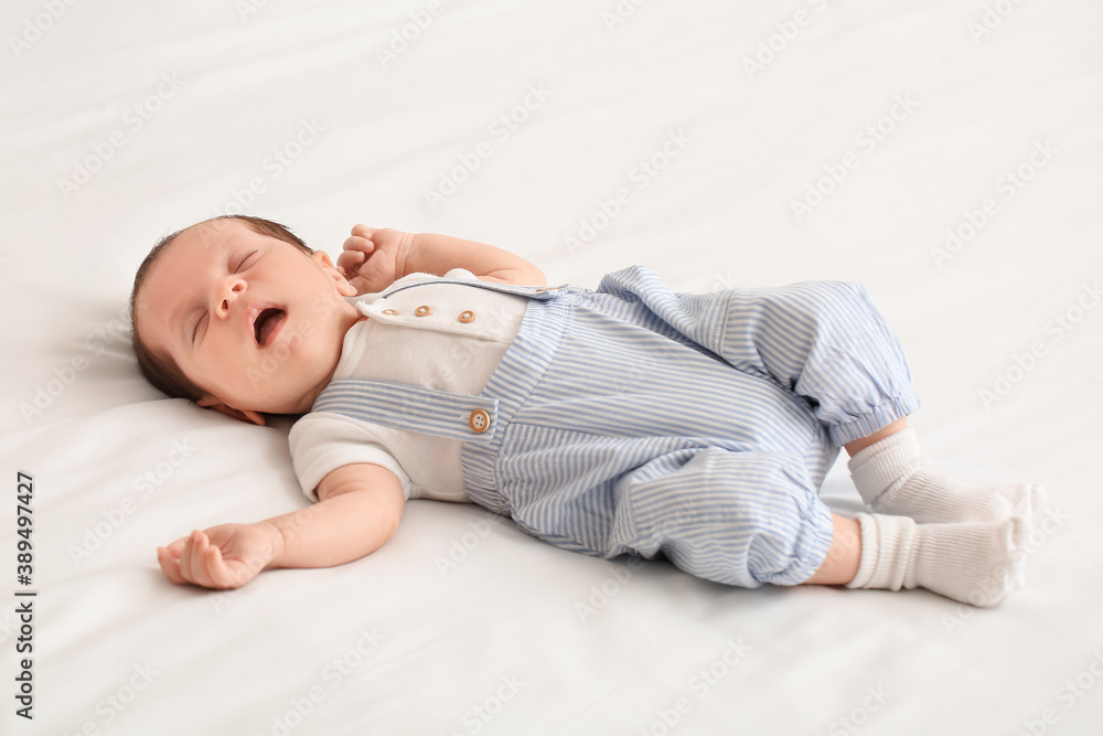 Cute little baby lying on bed