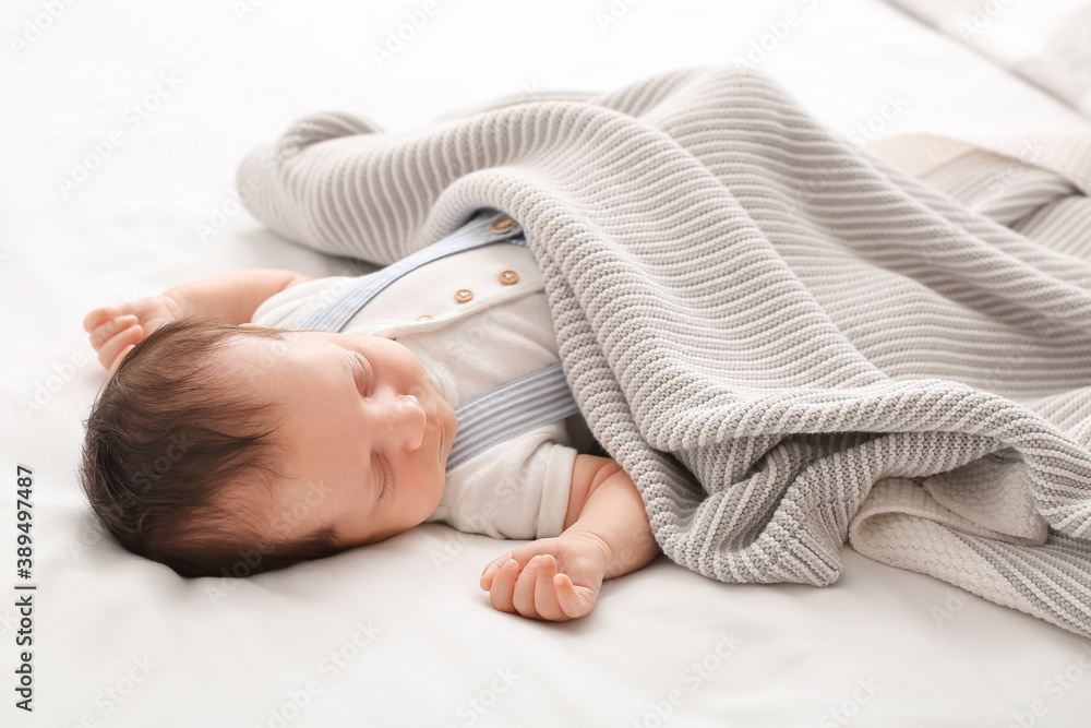 Cute little baby lying on bed