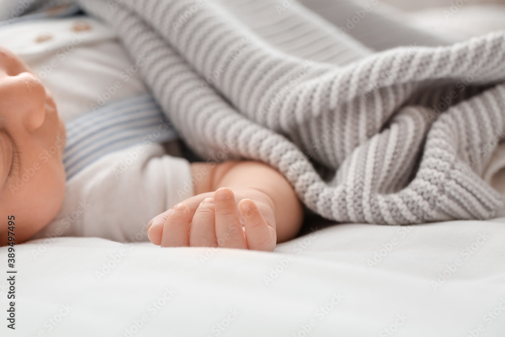 Cute little baby lying on bed