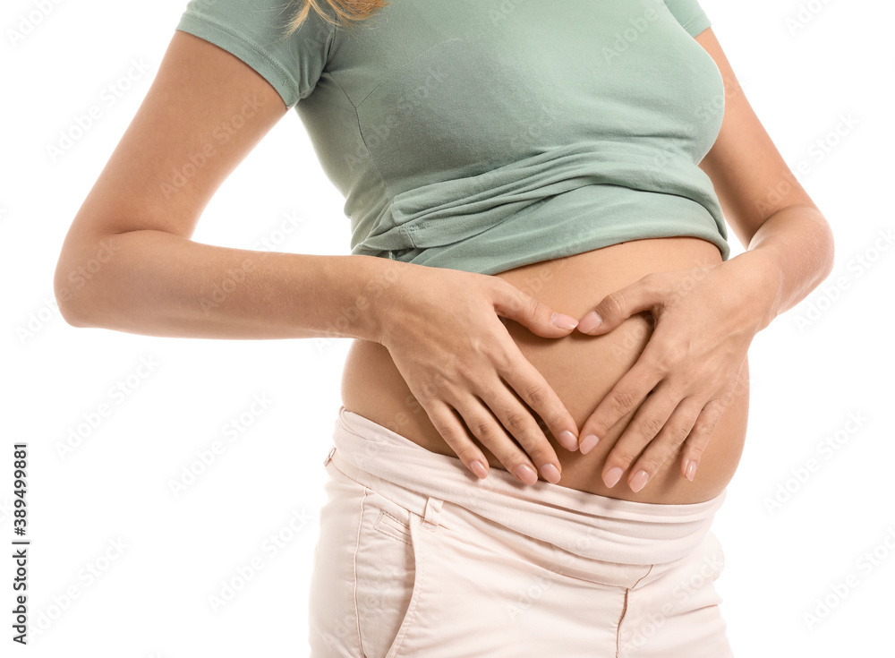 Beautiful pregnant woman making heart with her hands on white background