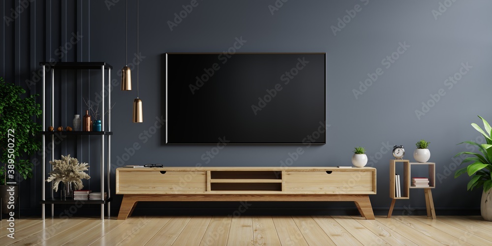 LED TV on the dark wall in living room with wooden cabinet,minimal design.