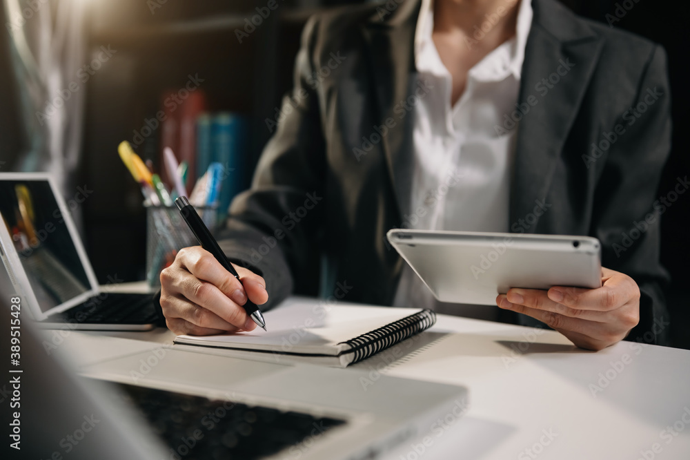 businessman hand working with new modern computer and writing on the notepad strategy diagram as con