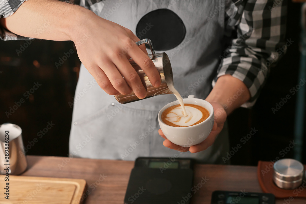 Barista making hot coffee in cafe, closeup