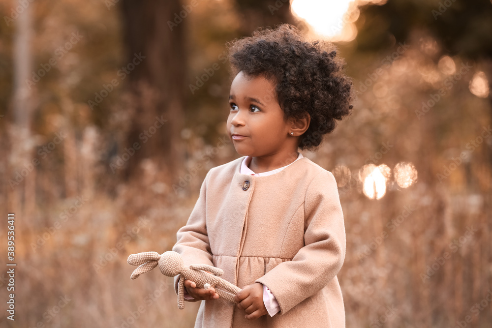 Cute African-American baby girl in autumn park