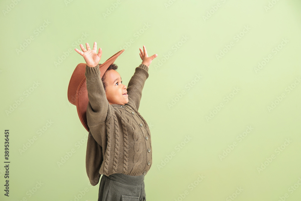 Stylish African-American baby girl on color background