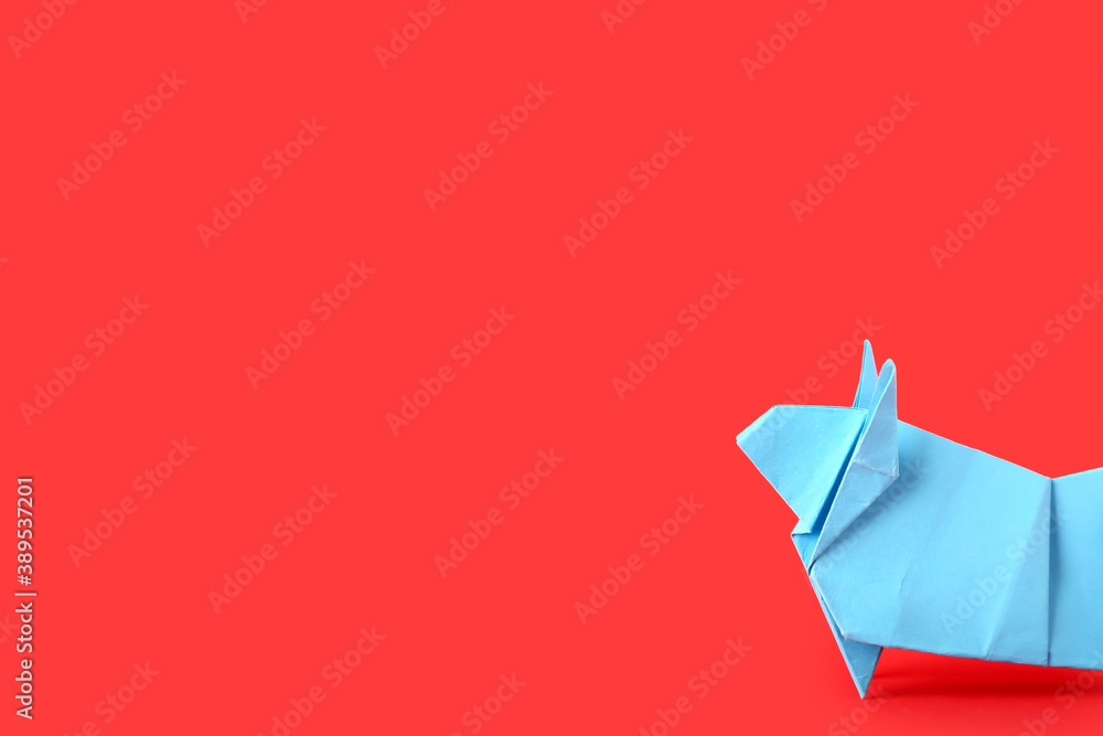 Origami bull as symbol of year 2021 on color background