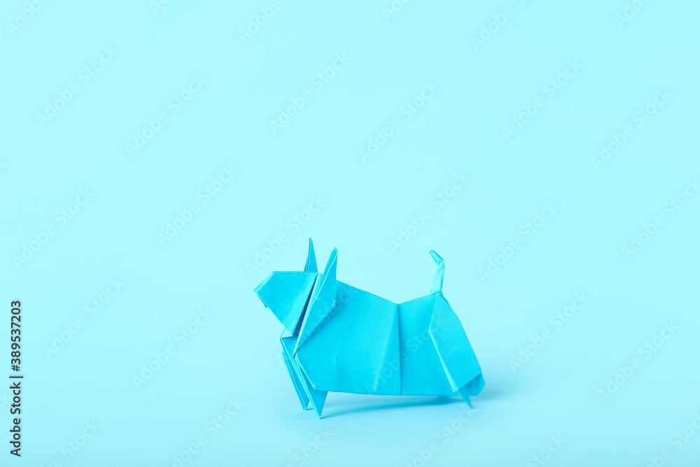 Origami bull as symbol of year 2021 on color background