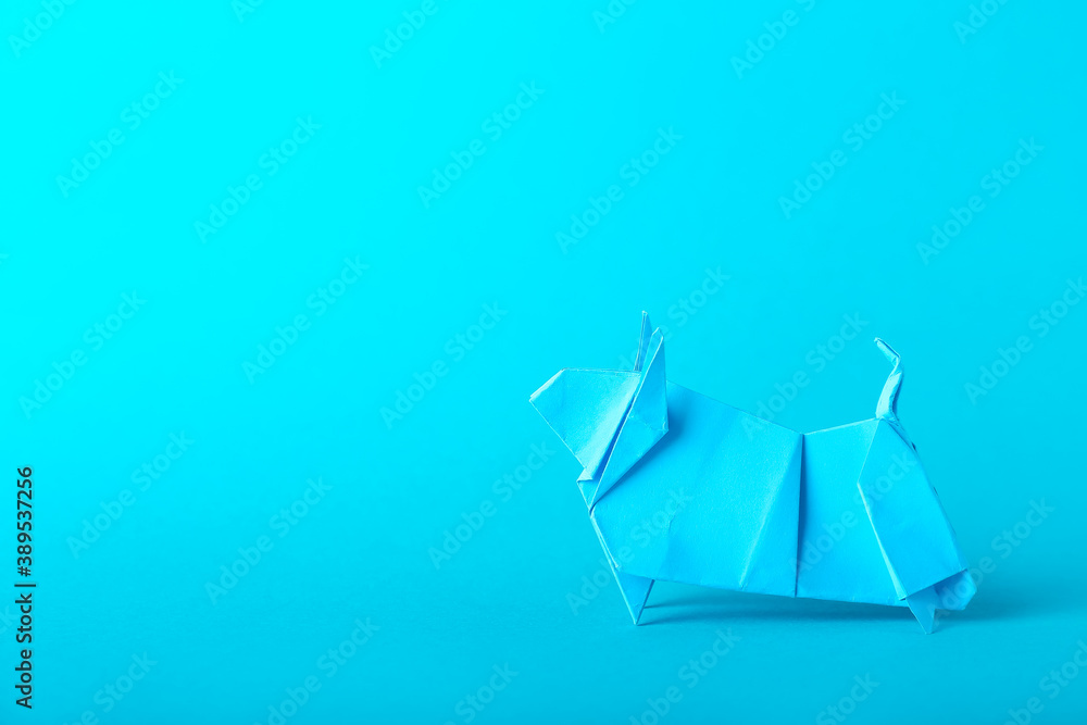 Origami bull as symbol of year 2021 on color background