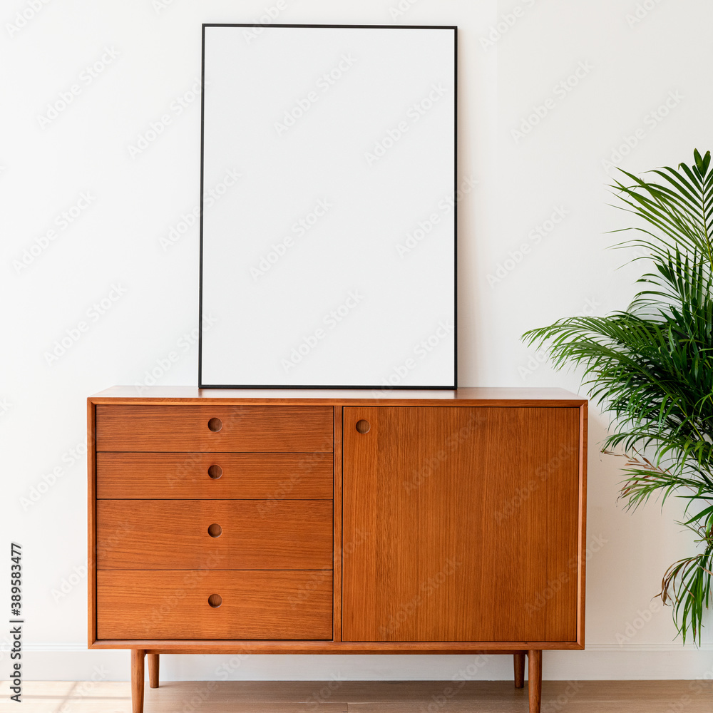 Blank picture frame on a wooden cabinet