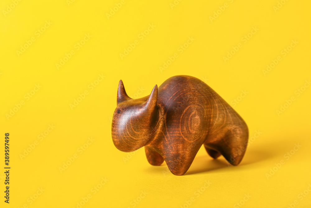 Figurine of bull as symbol of year 2021 on color background