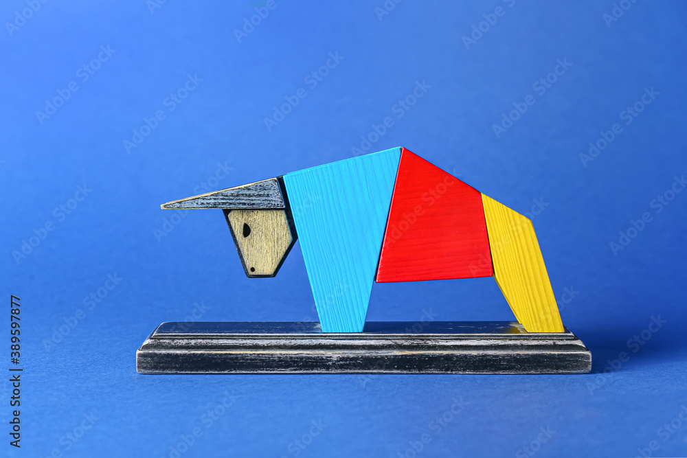 Figurine of bull as symbol of year 2021 on color background