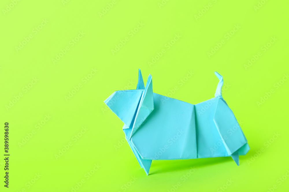 Origami bull as symbol of year 2021 on color background