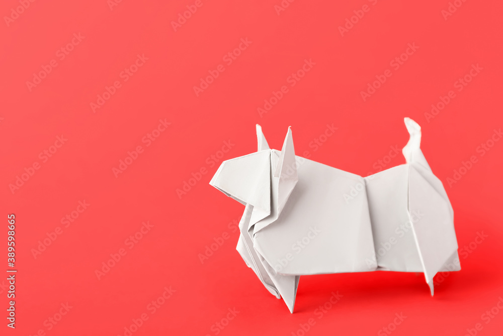 Origami bull as symbol of year 2021 on color background