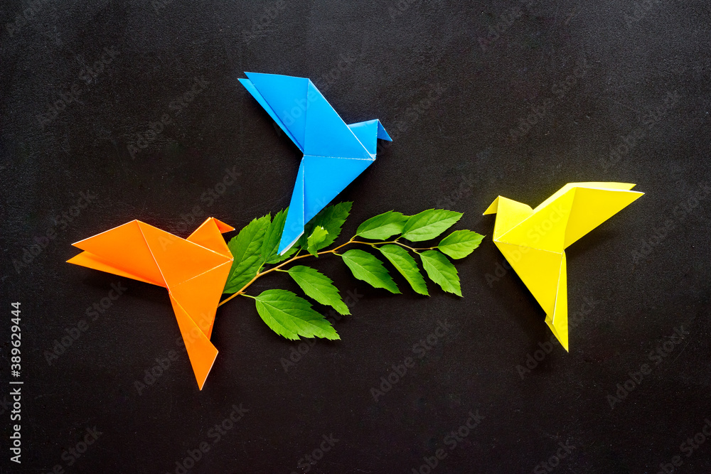 Colored origami - paper birds with leaves, overhead view