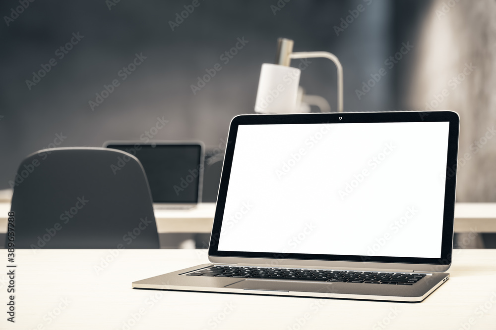 Coworking office and laptop with blank screen