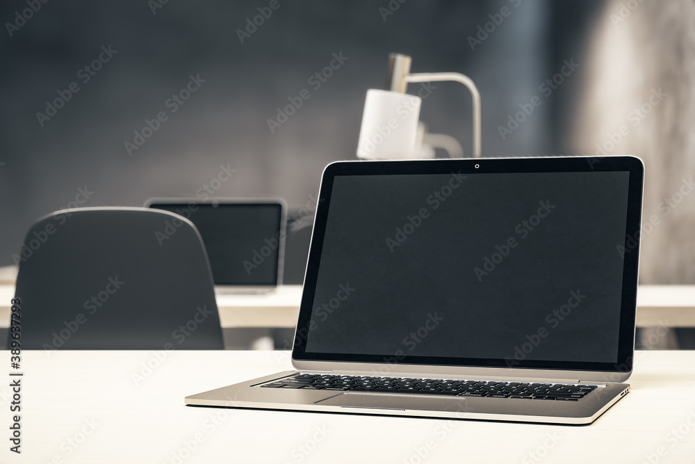 Interior of stylish office with laptop on table