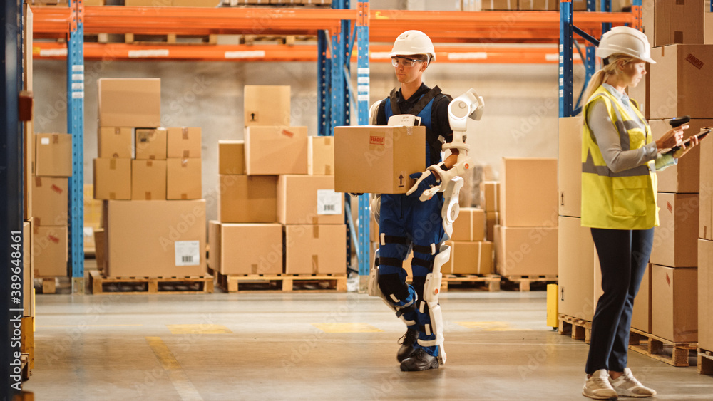 High-Tech Futuristic Warehouse: Worker Wearing Advanced Full Body Powered exoskeleton, Walks with He