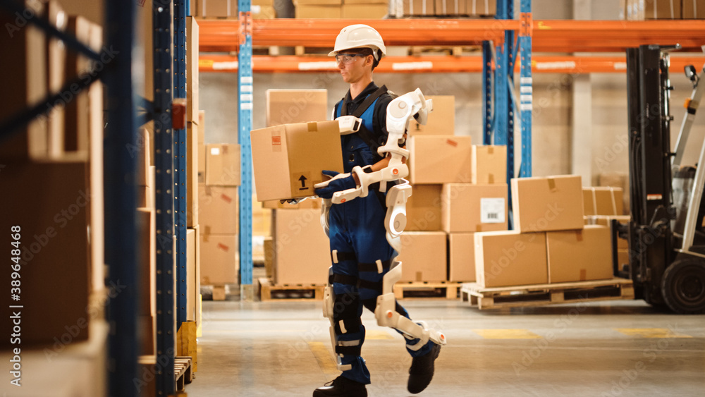 High-Tech Futuristic Warehouse: Worker Wearing Advanced Full Body Powered exoskeleton, Walks with He