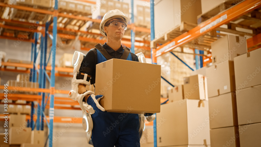 High-Tech Futuristic Warehouse: Worker Wearing Advanced Full Body Powered exoskeleton, Walks with He