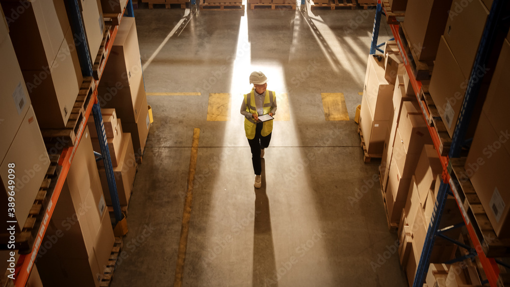 Top-Down View: Worker Wearing Hard Hat Checks Stock and Inventory Using Digital Tablet Computer in t