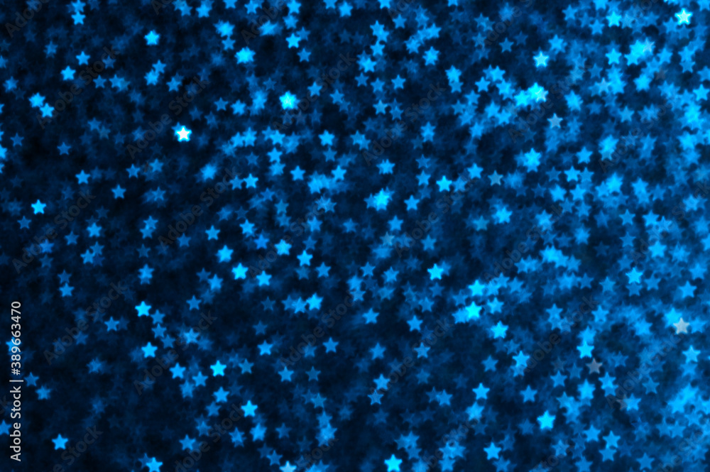 Blue holiday glitter background with stars bokeh.