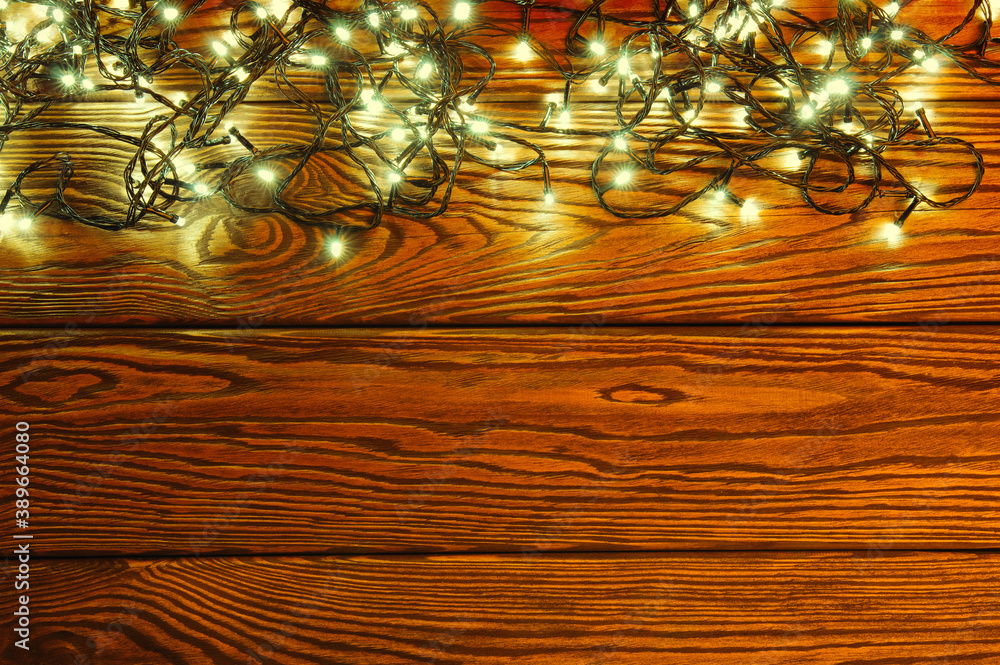 Сhristmas lights, background  ornaments on wood