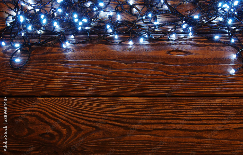 Сhristmas lights, background  ornaments on wood