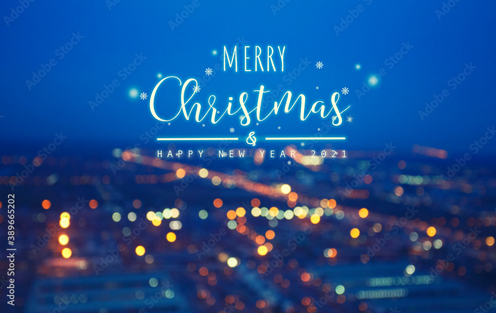 word text merry Christmas on a white background and Blurred Photo bokeh of cityscape