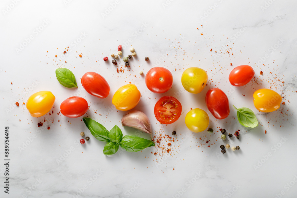 Multicolored  mixed cherry tomatoes scattered on marble table