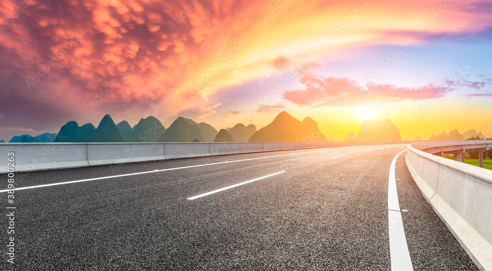 Country asphalt road and green mountain natural scenery in Guilin at sunrise,China.